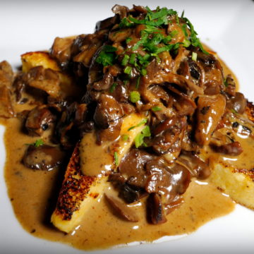 Grilled polenta covered with wild mushroom sauce