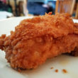 Fried chicken thigh enveloped in crunchy red-gold crust