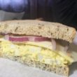 Egg salad sandwich on rye with onions and cheese