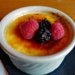 Crisp-topped creme brulee is topped with fresh berries
