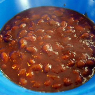 BBQ-sauced beans in a blue bowl
