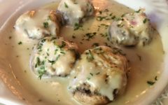 Mushrooms are stuffed with crab and topped with melted cheese