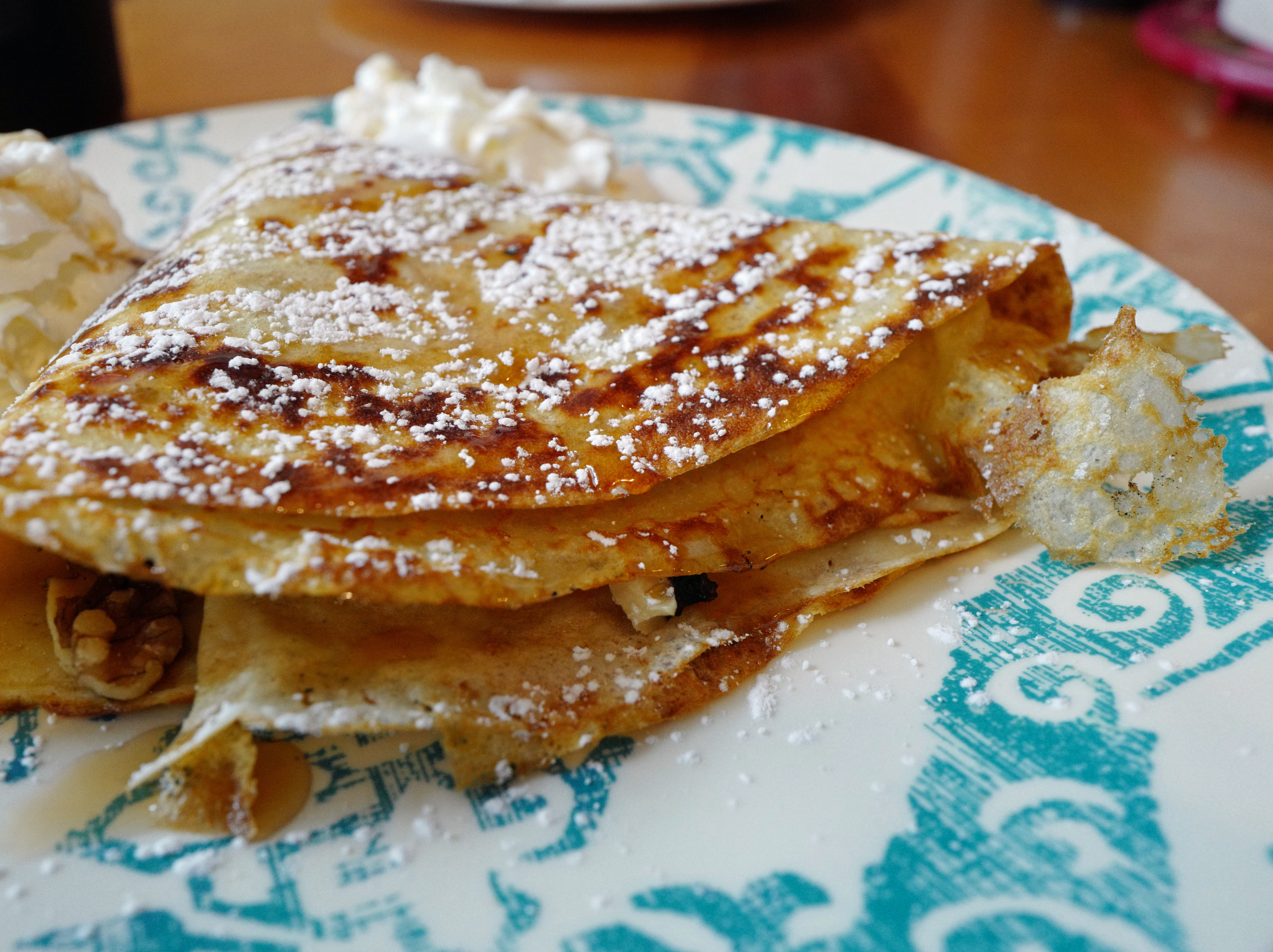 Paper-thin crepes, dusted with powdered sugar, envelop bananas, walnuts, maple syrup and brown sugar