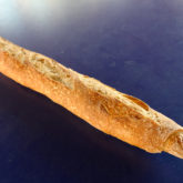 Long, slender tube of bread with light tan surface