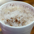 Styrofoam cup of horchata, dusted with cinnamon