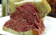 Thin-sliced, brick-red corned beef is piled ridiculously high between two slices of rye bread at Sylman's Restaurant in Cleveland, OH