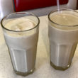 Two glasses: coffee milk shake on the left, coffee milk (no ice cream) on the right