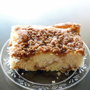 Modest square of coffee cake shows veins of cinnamon and judicious streusel top