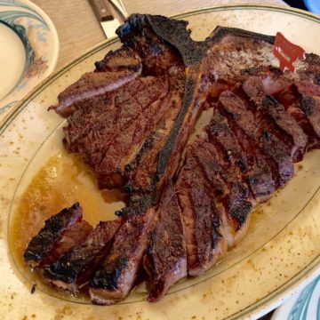 Porterhouse steak, sliced and ready to eat at Peter Luger Steak House in Brooklyn, NY