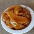 Bowl contains cooked-soft slices of apple in sweet natural syrup