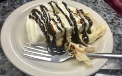 Peanut butter cream pie is drizzled with chocolate syrup.