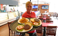 Waitress sows a tray of hamburgers
