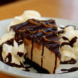 Peanut butter pie, frosted with chocolate, comes on a chocolate-cookie crust