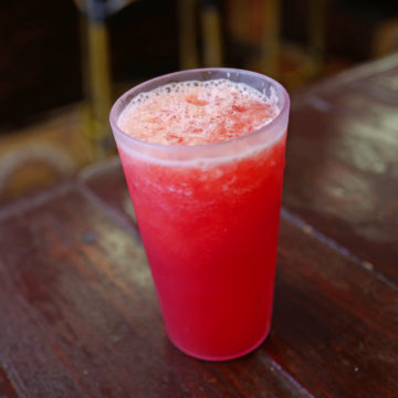 Glass of bright pink watermelon juice ... Cuban burgers & fruit juice