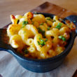 Macaroni & cheese, spangled with herbs, comes in a small cast-iron pot