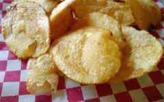 Crisp circular potato chips on a red-checked tablecloth