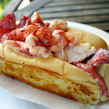 Picked lobster meat is piled high in a long bun that has been butter-grilled on its sides ... Maine lobster roll