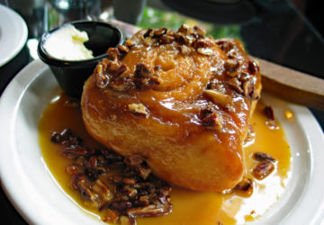 Sticky bun, crowded with nuts, wallows in a pool of caramel syrup.