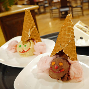 Children's dessert: upside-down ice cream cones with faces on the scoops of ice cream