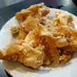 A plate of crisp-fried pieces of chicken skin for munching ... Jewish deli reborn