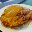 Crisp potato pancakes, topped with apricot apple sauce, show the potato shreds of which they are made ... Jewish deli reborn
