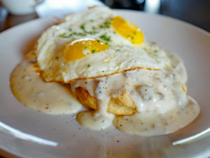 Biscuits and gravy topped with fried eggs ... stylin' breakfast