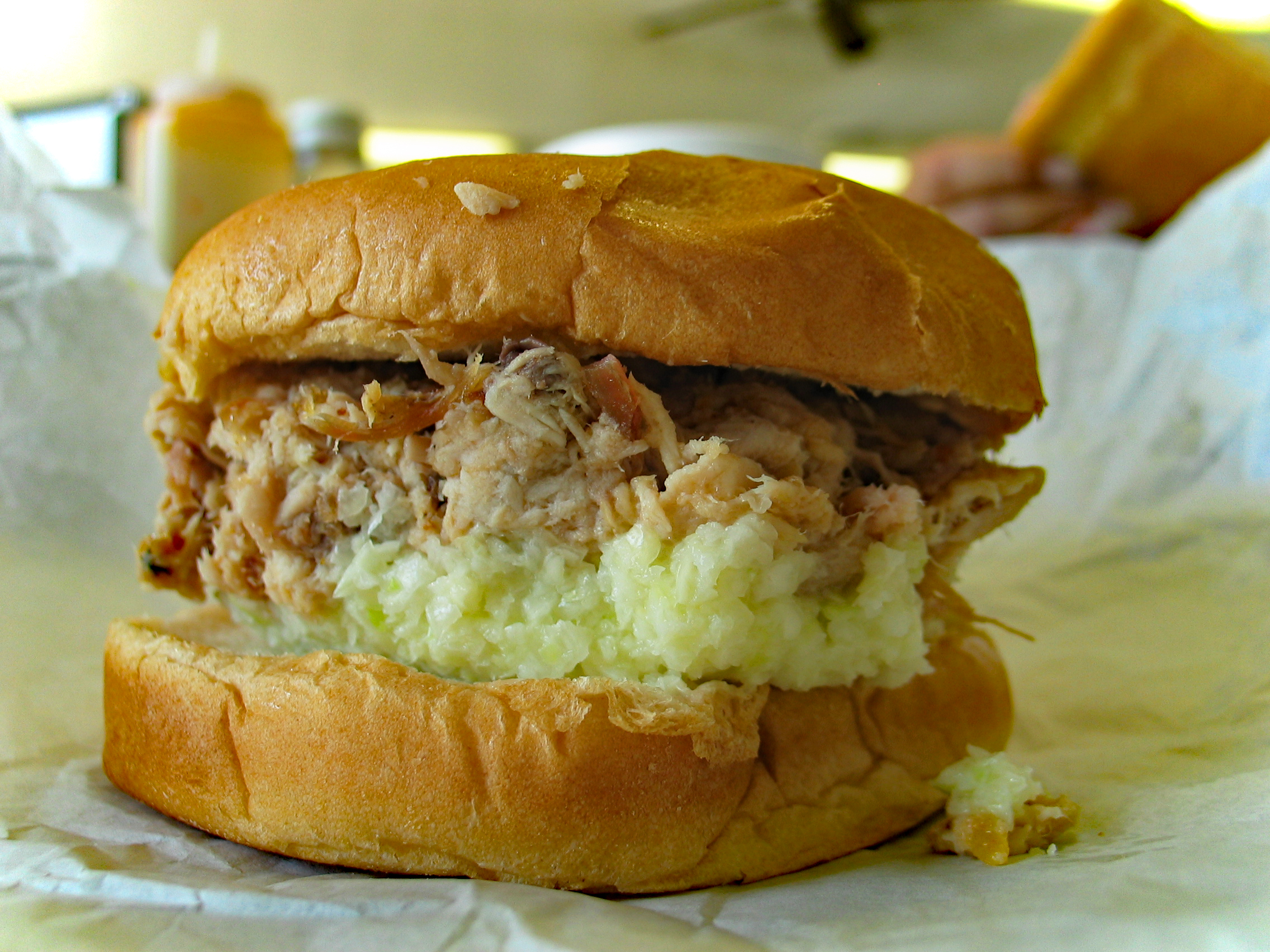 Finely chopped pork and cole slaw piled in a bun