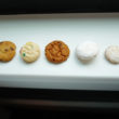 Five different little bite-size cookies on a shelf at Byrd's of Savannah