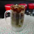 A frosty mug set on a boomerang-formica table holds effervescent root beer. ... car hop service