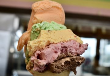 A photo of the original Rainbow Cone, a Chicago-style ice cream shop's signature treat featuring five flavors of ice cream on a single cone.