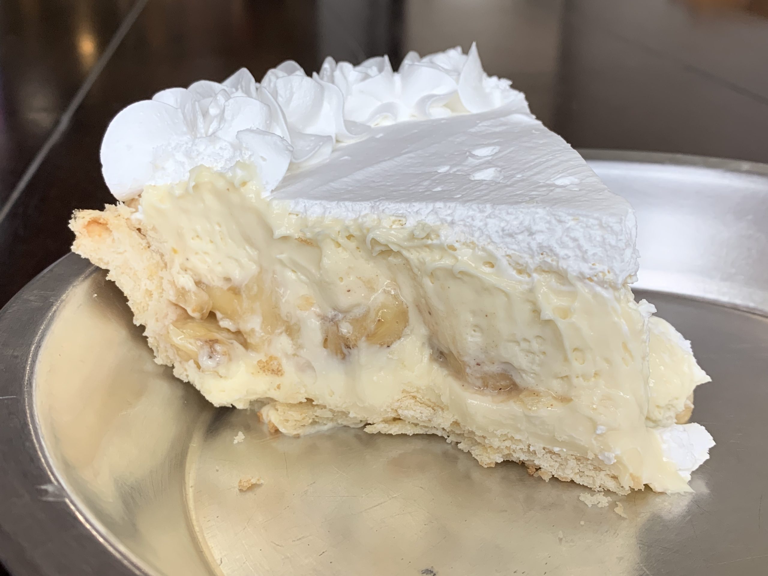 Cream pie slice is packed with bananas