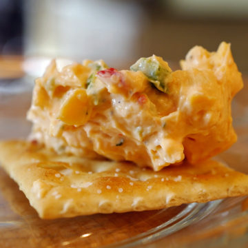 Close view of a doot of pimento cheese on a saltine cracker