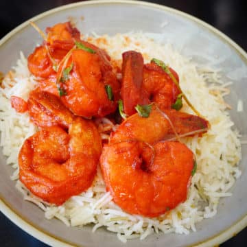 Bright, pepper-saturated shrimp bedded atop a bowl of saffron rice
