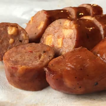 Slices of sausage link show nuggets of jalapeno cheese within