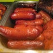 Buffet tray of plump pink hot link sausages