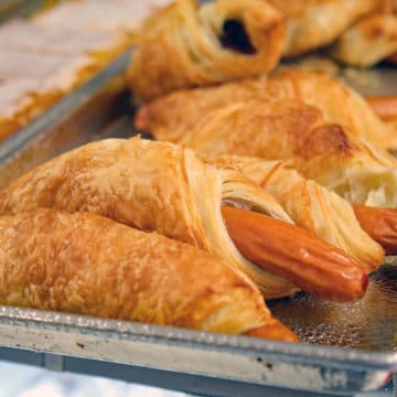 Full-size hot dogs are wrapped in elegant, flaky pastry