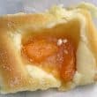 Small, soft rectangular pastry contains pieces of apricot in its center