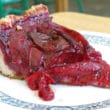 Slice of beet-red plum tart sports a cookie crust