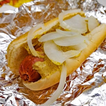 Half-smoke sausage in a bun with onions and mustard