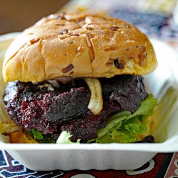 Bunned and dressed burger looks like beef, but is made with beans, beets, and rice.