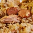 Close view of chicken bog shows tender chicken and discs of sausage bogged down in rice.