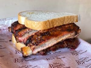Half rack of ribs between two slices of white bread Arthur Bryant's Legendary BBQ In Kansas City, MO