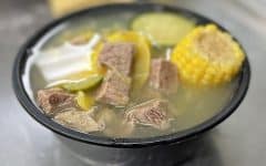 Bowl of soup with beef, corn, and squash ... Apache burger